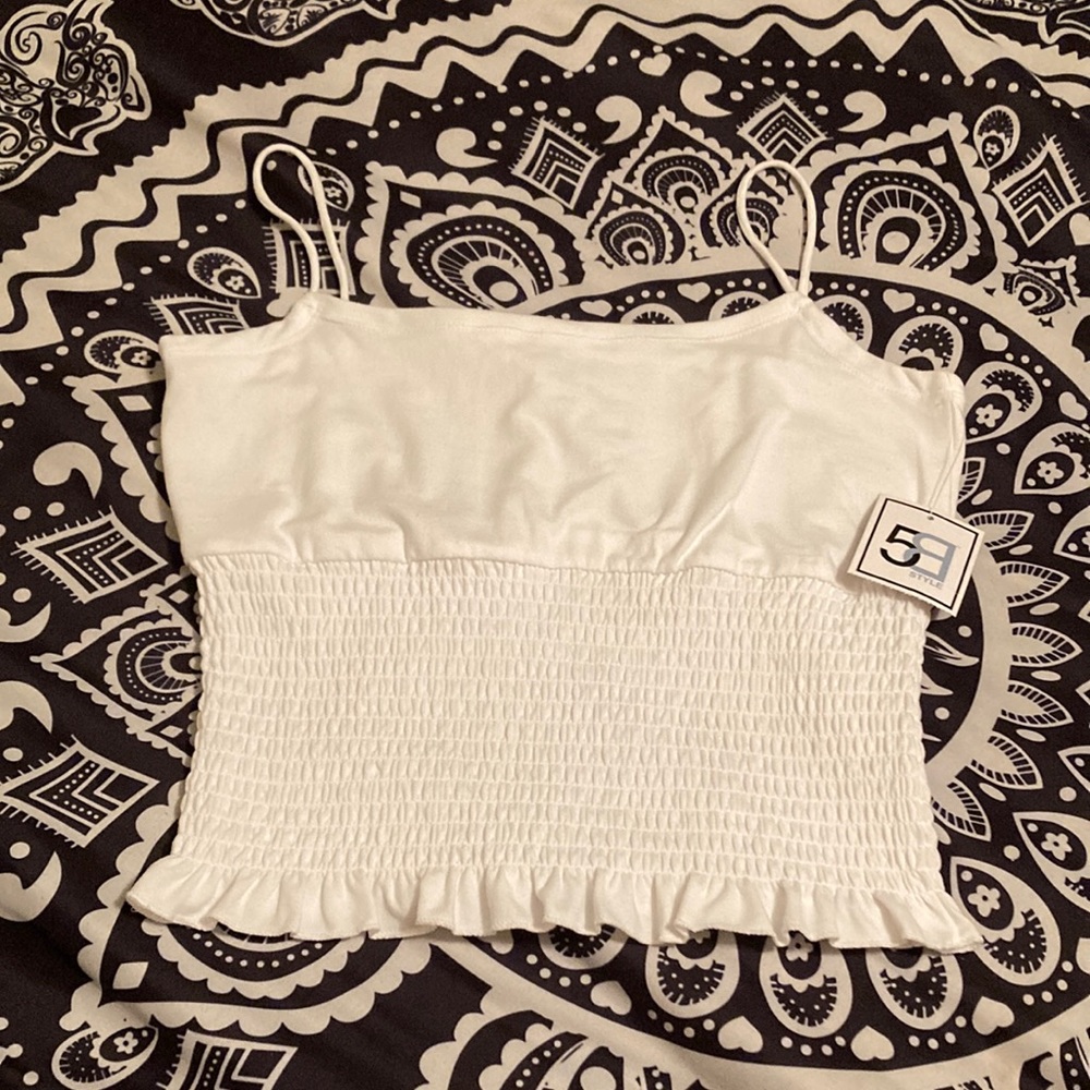 A white ruffled tank. Size small.